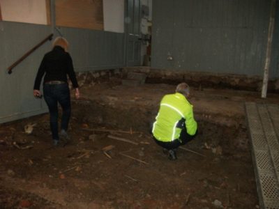 Martin & Miya inspect floor by stage